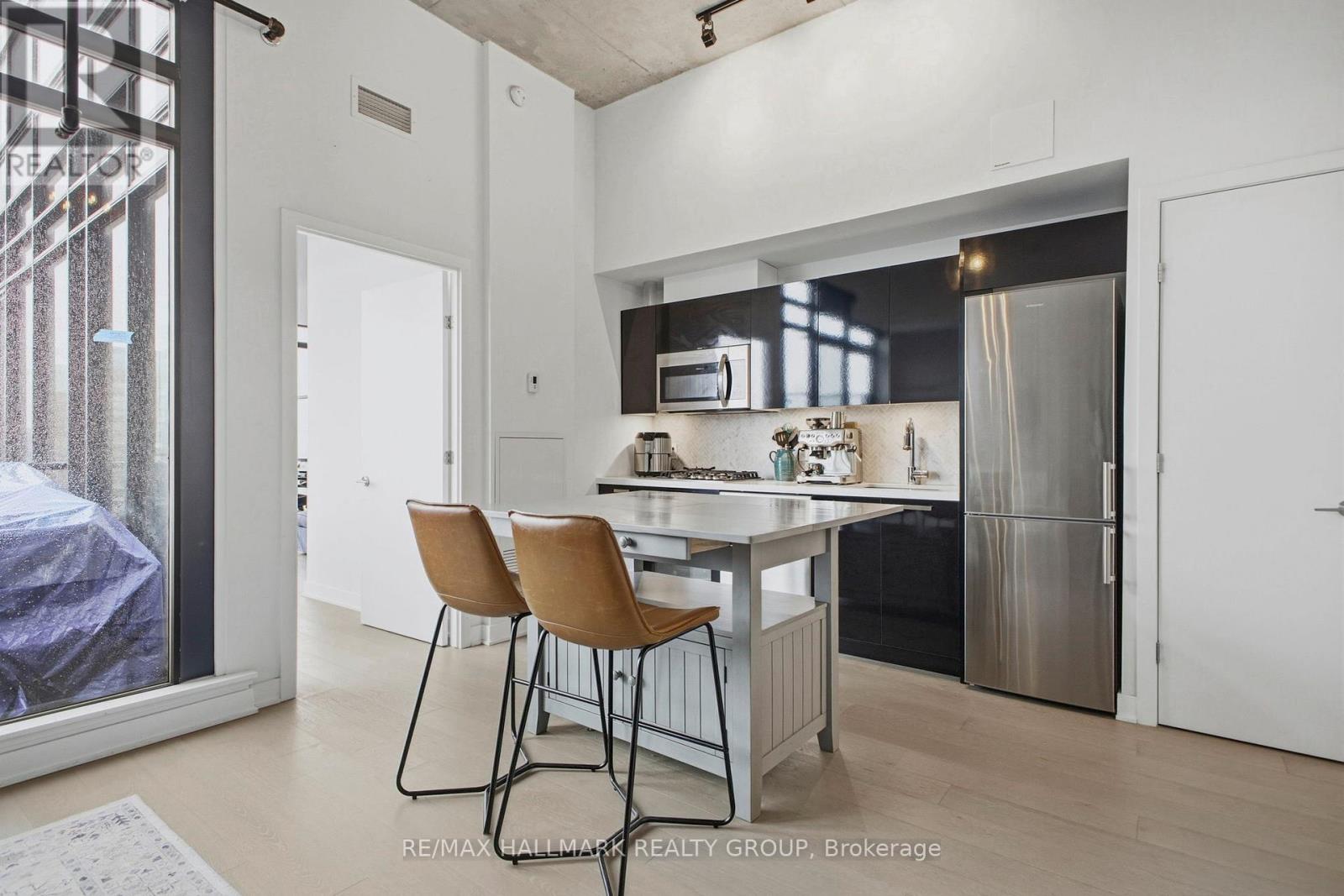 A modern kitchen with a dining table and chairs.