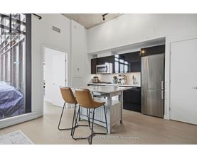 A modern kitchen with a dining table and chairs.