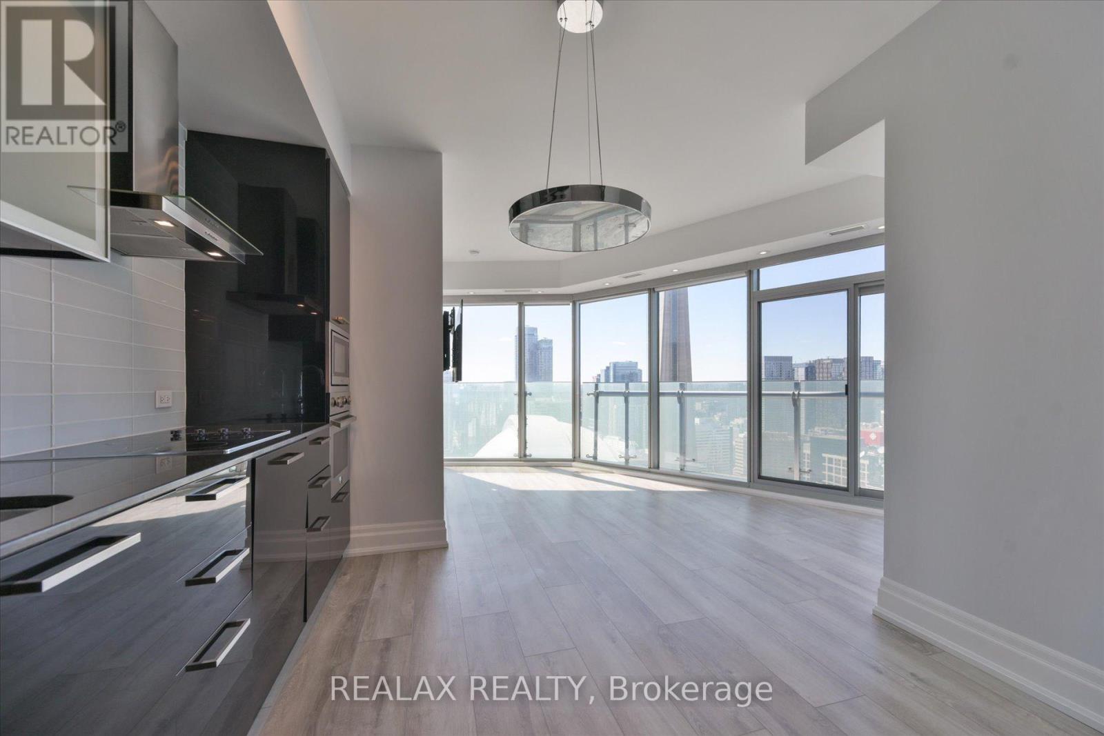 A spacious kitchen with a large island and a view of the city.