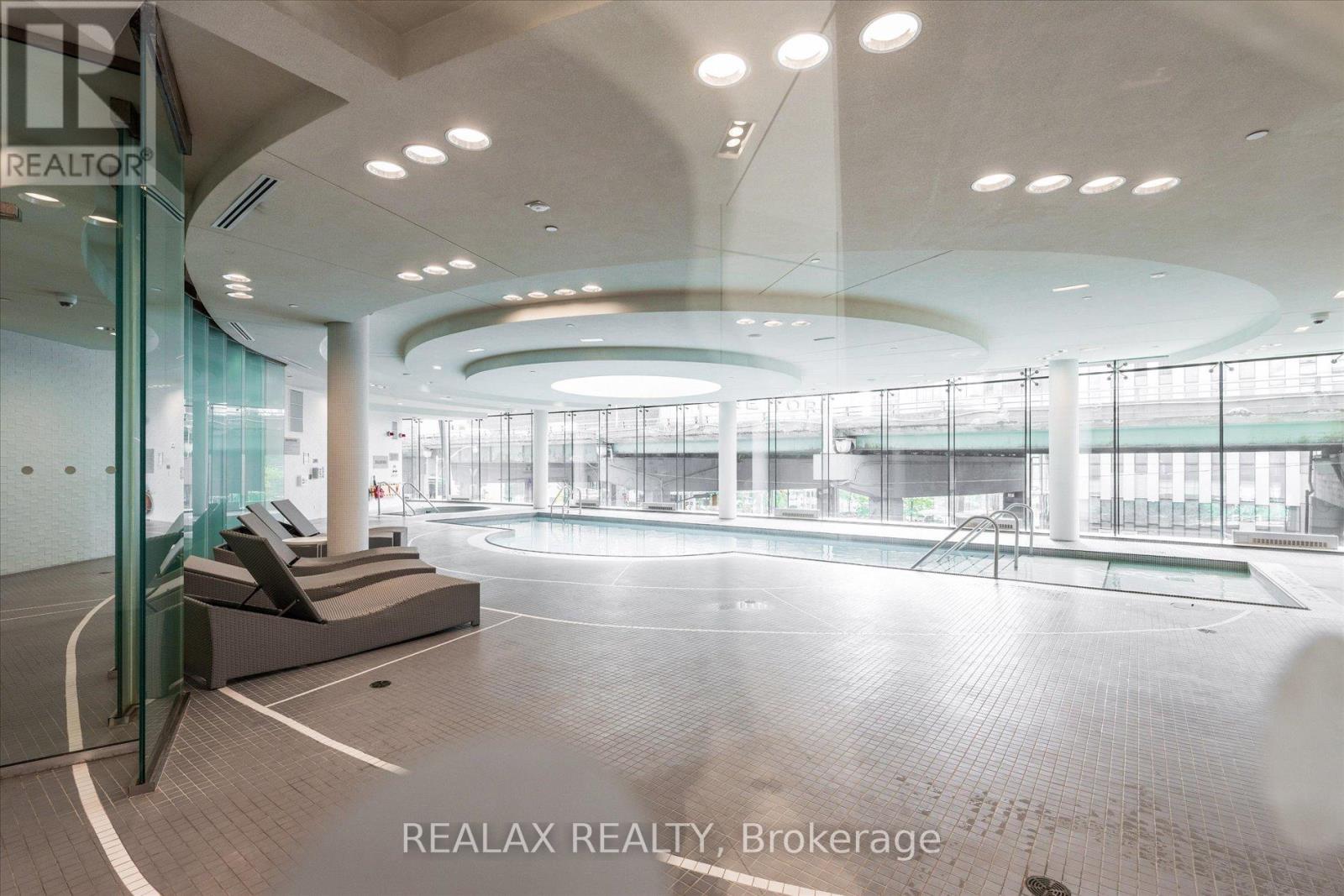A large, empty indoor space with a pool table and a seating area.