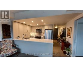 A kitchen with a sink, stove, and refrigerator.