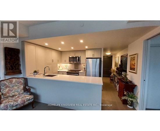 A kitchen with a sink, stove, and refrigerator.