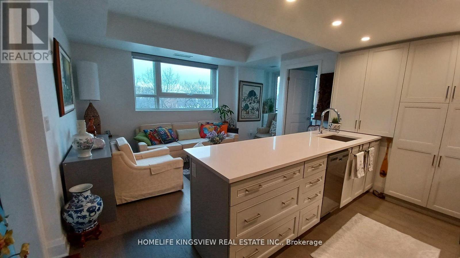 A kitchen with white cabinets and a large island.