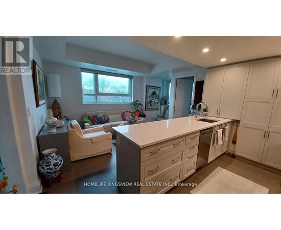 A kitchen with white cabinets and a large island.