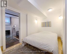 A bedroom with a bed, a window, and a rug.