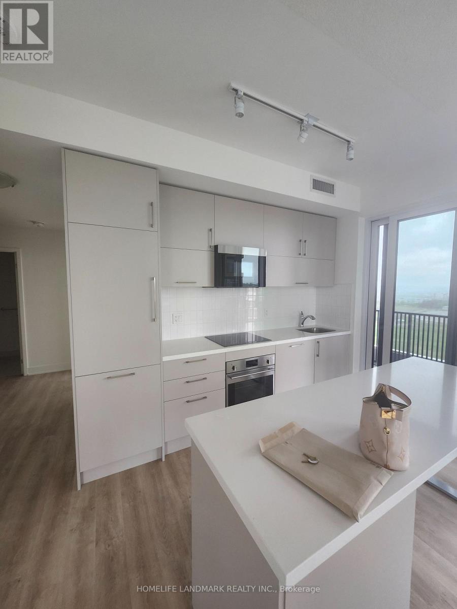 A kitchen with white cabinets and a white counter top.