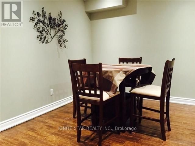 A dining room with a table and chairs.