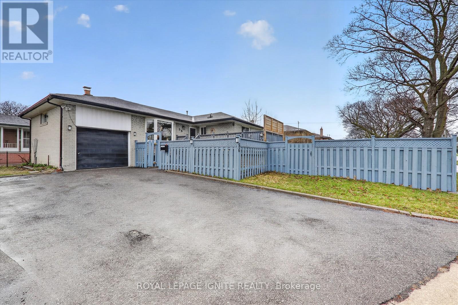 A large house with a blue fence in front of it.
