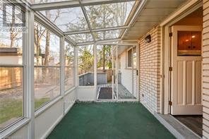 A sunny day at the beach house with a glass roof and a green pool.