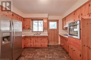 A kitchen with wooden cabinets and a refrigerator.
