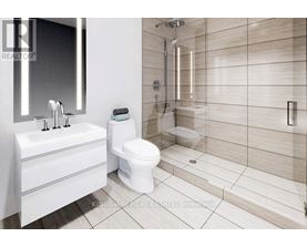 A white bathroom with a toilet, sink, and shower.