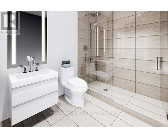 A white bathroom with a toilet, sink, and shower.