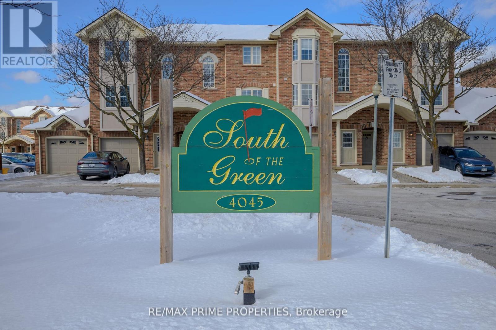 A sign for South Green 4045 stands in front of a building.