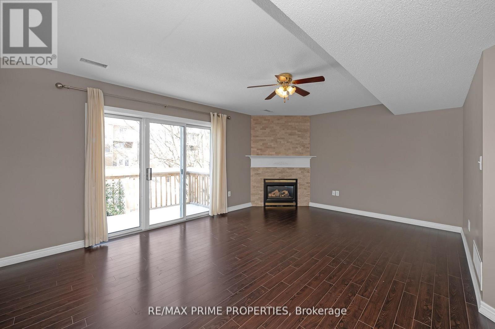 A spacious room with a fireplace and sliding glass doors.