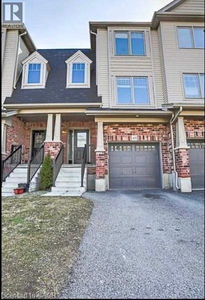 A two-story house with a garage and a driveway.