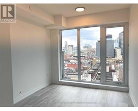A realtor's image of an empty room with a view of the city.