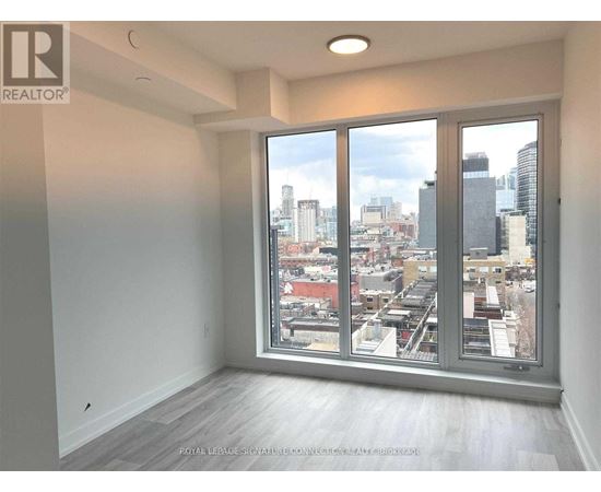 A realtor's image of an empty room with a view of the city.