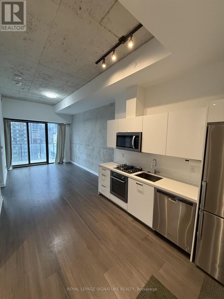 A kitchen with white cabinets and stainless steel appliances.