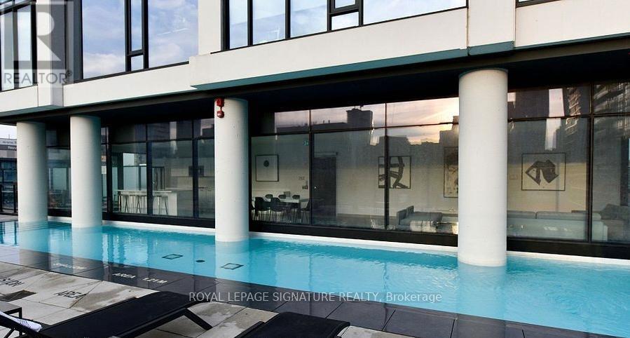 A modern building with a pool in front.