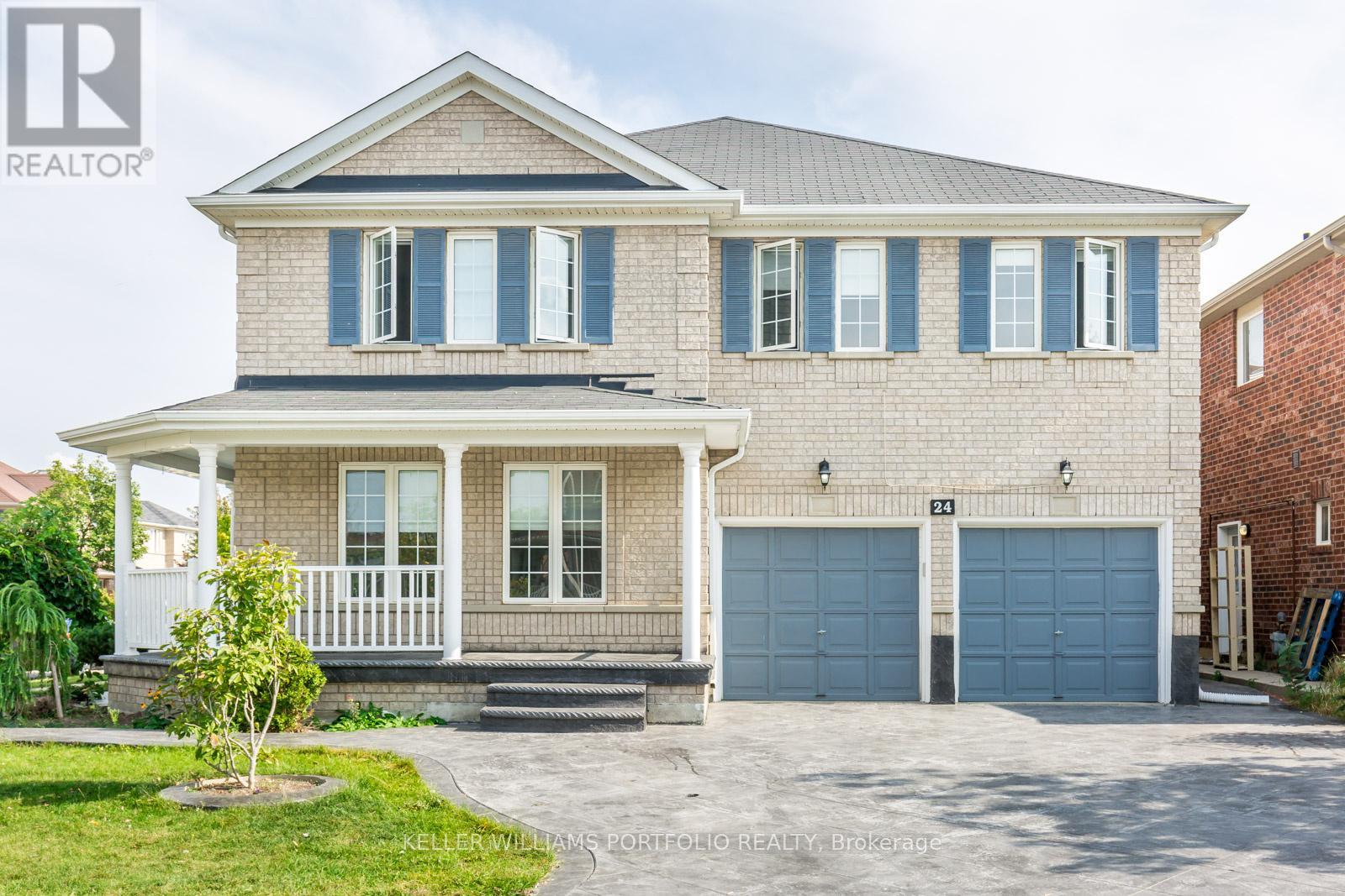 A house with a grey roof and blue garage doors.