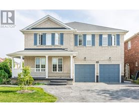 A house with a grey roof and blue garage doors.