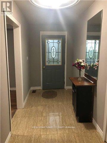 A hallway with a wooden floor and a blue door.