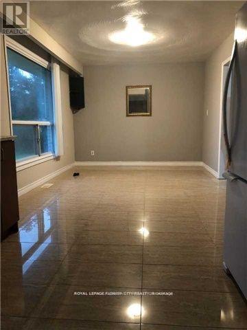 A spacious room with a tiled floor and a window.
