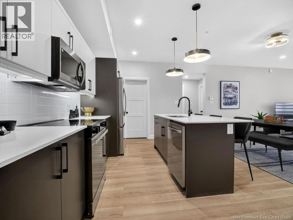A modern kitchen with dark brown cabinets and a white countertop.