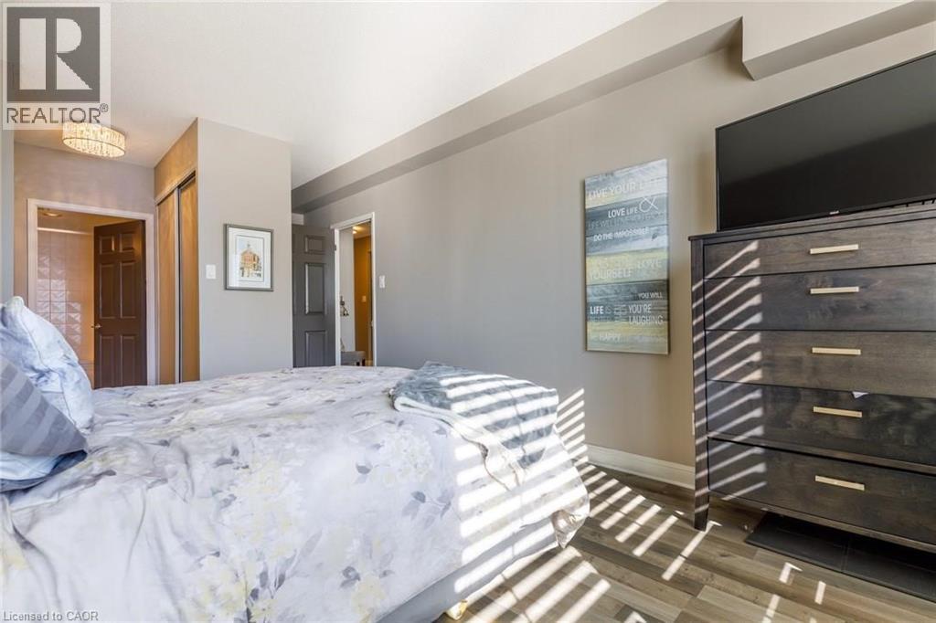 A bedroom with a large bed and a wooden dresser.