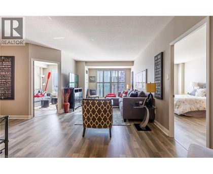 A living room with a brown patterned chair in the center.