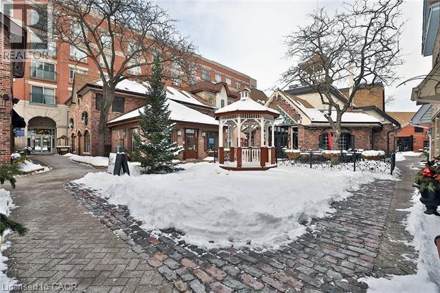 A gazebo sits in the middle of a snow-covered courtyard.
