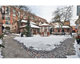 A gazebo sits in the middle of a snow-covered courtyard.