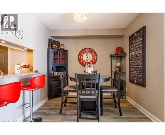 A dining room with a table set for four.