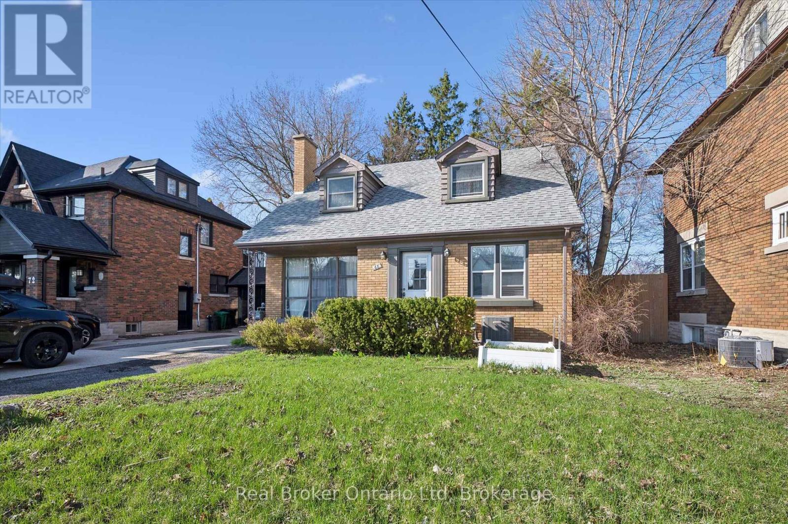 A house with a brick facade and a large front yard.
