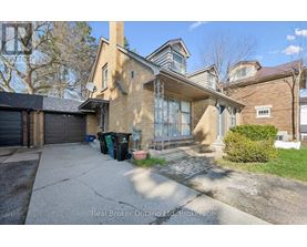 A house with a driveway and a garage is for sale.