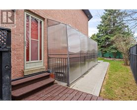 A brick building with a glass fence and a sign that says "REALTOR" on it.