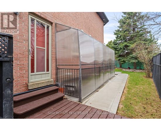 A brick building with a glass fence and a sign that says "REALTOR" on it.