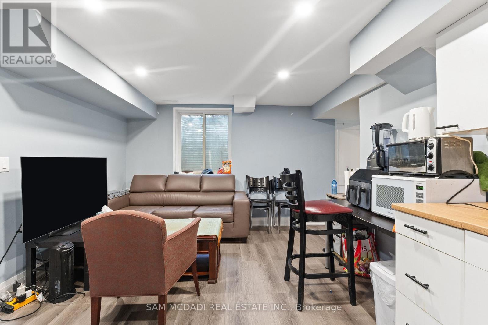 A living room with a brown leather couch and a wooden coffee table.