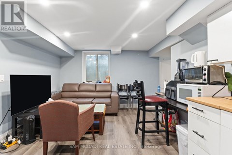 A living room with a brown leather couch and a wooden coffee table.