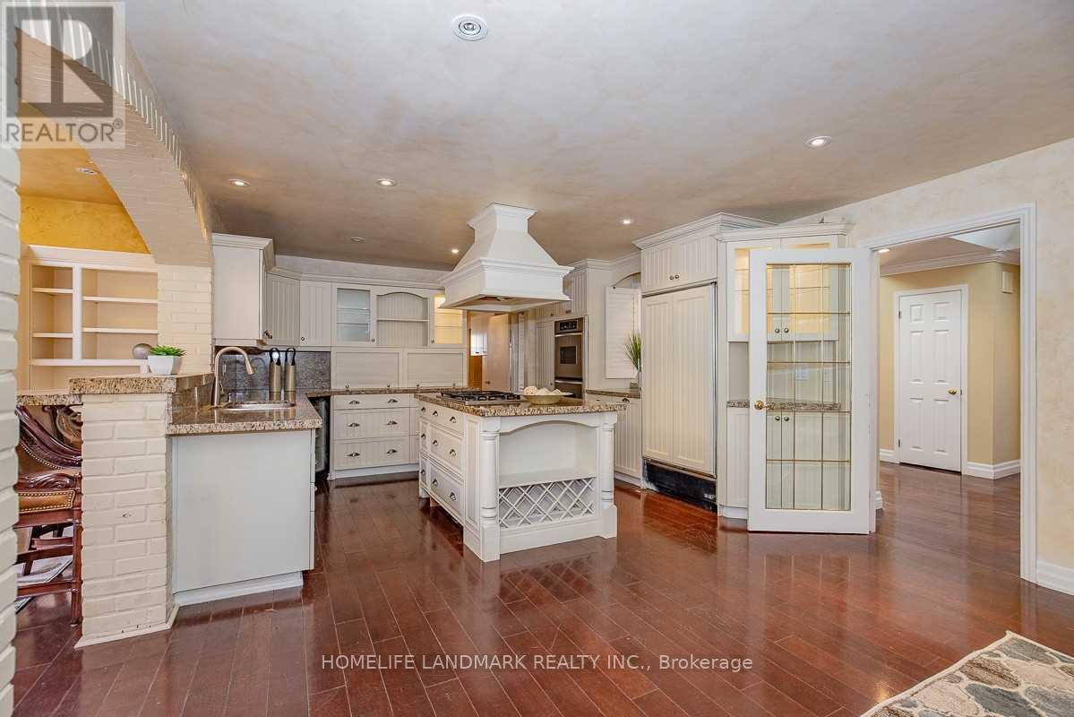 A spacious kitchen with white cabinets and a central island.