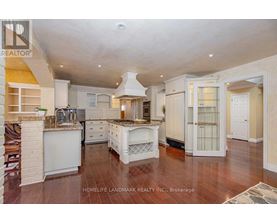 A spacious kitchen with white cabinets and a central island.