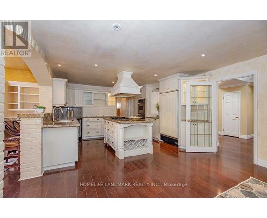 A spacious kitchen with white cabinets and a central island.