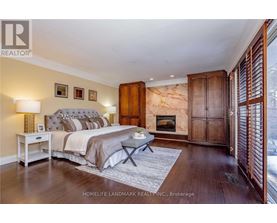 A bedroom with a large bed and a fireplace.