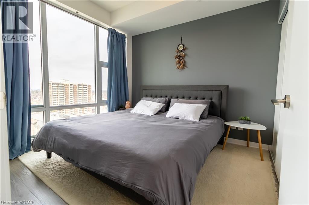 A bedroom with a large bed and a view of the city.