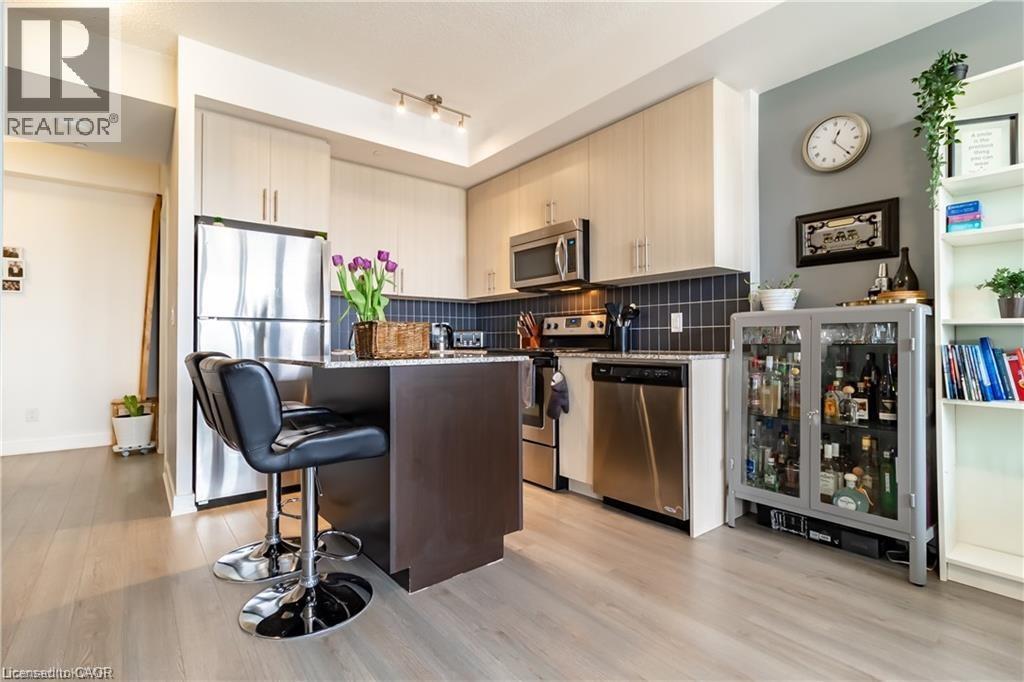A modern kitchen with a bar area and a chair.