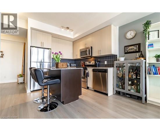 A modern kitchen with a bar area and a chair.