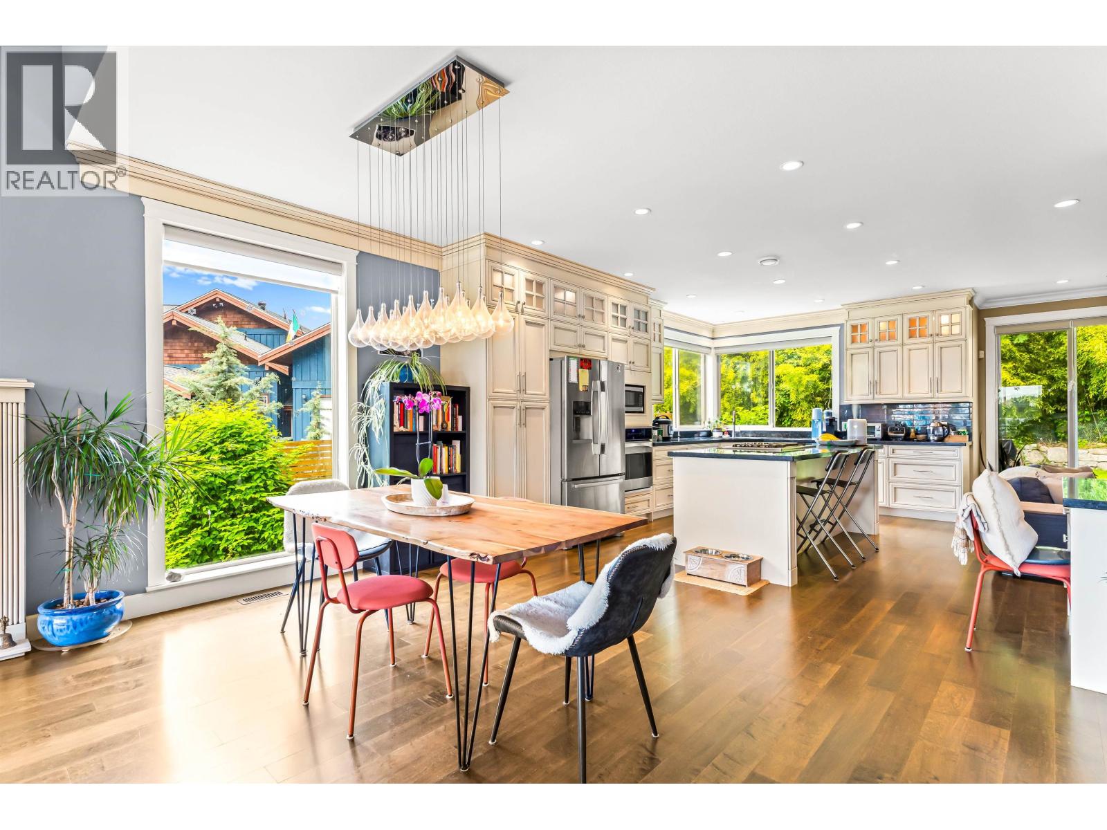 A modern kitchen with a dining table and chairs.