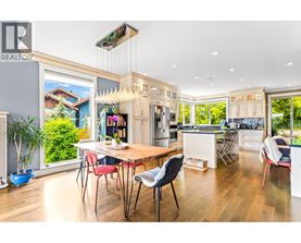 A modern kitchen with a dining table and chairs.