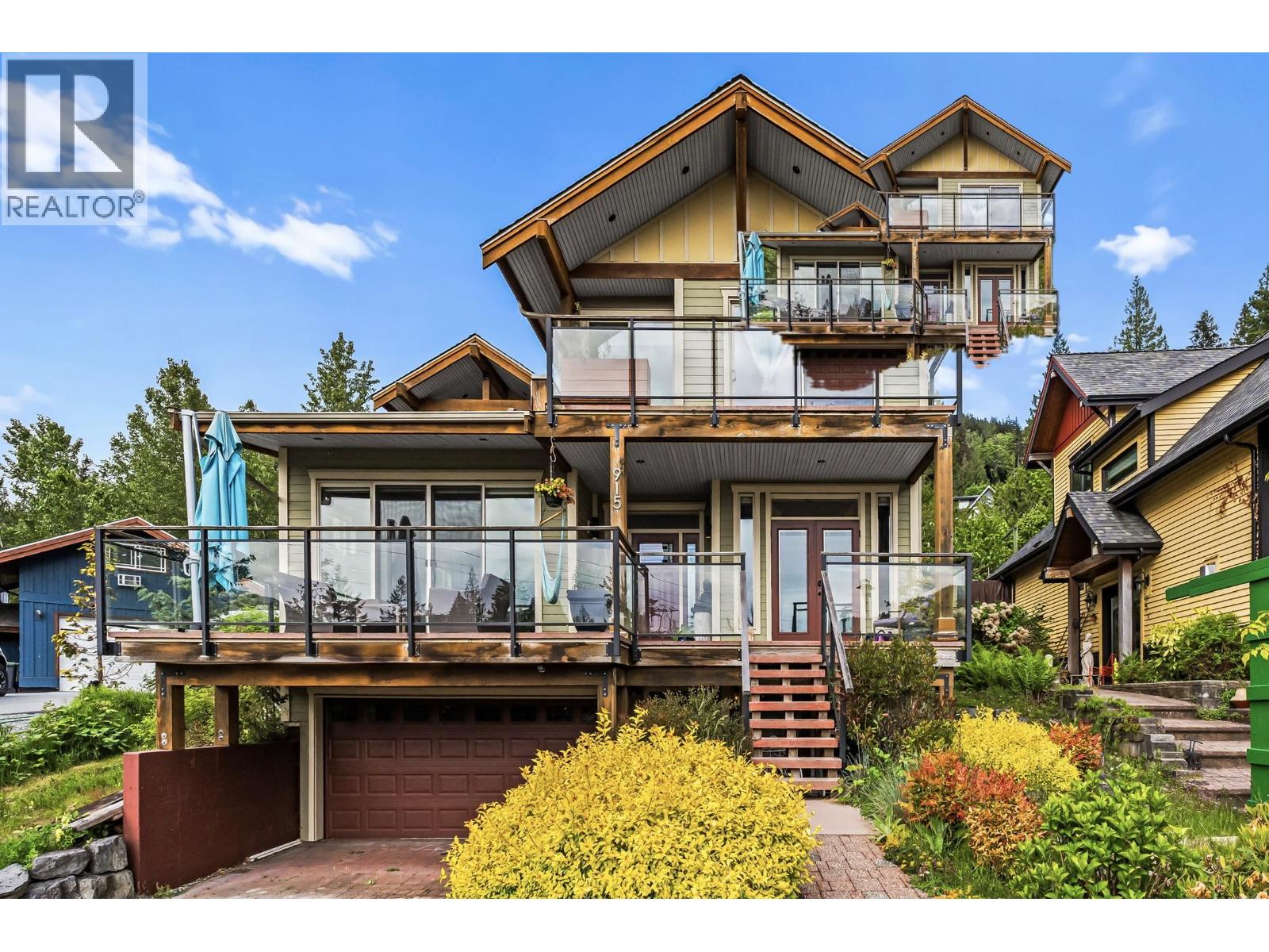 A large, multi-level house with a balcony and a garage.