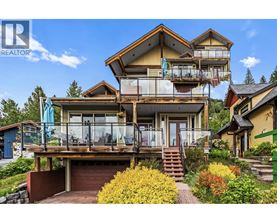 A large, multi-level house with a balcony and a garage.